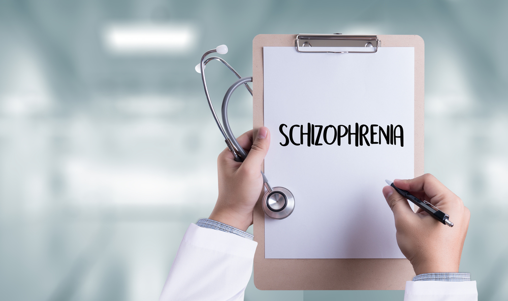 doctor holding a stethoscope and board with Schizophrenia written